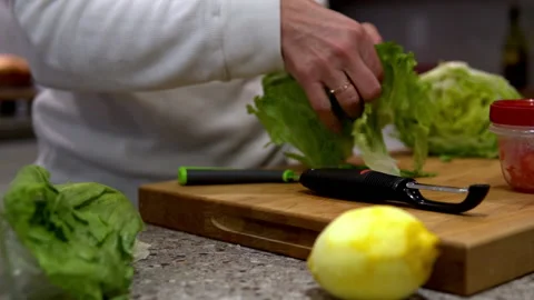 Cutting lettuce for salad Stock Footage 145166395
