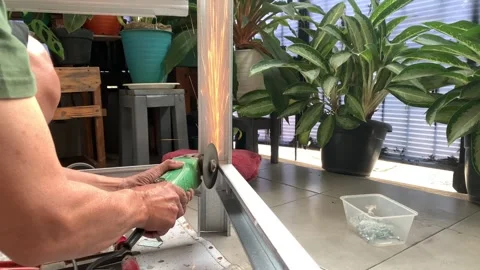 Cutting light steel using a hand grinder machine creates fine sparks in workshop 스톡 동영상 268957164