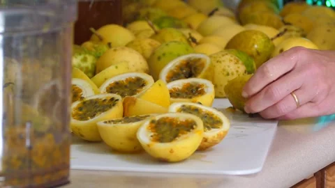 Cutting lilikoi passion fruit for processing in a home kitchen Stock Footage 252921340