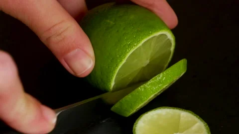 Cutting lime close up 4K black background Stock Footage 172211327