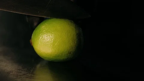 Cutting a lime in two parts Stock Footage 125458674