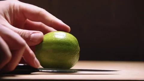 Cutting limes in slow motion Stock Footage 83862796