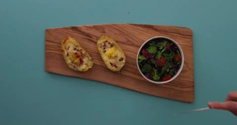 Cutting loaded potato in half 1 스톡 동영상 132149191