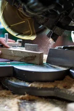 Cutting lumber with sliding compound miter saw outdoors. Home carpentry workshop Stock Photos