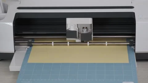 Cutting machine cut out details on yellow cardboard on blue mat. Stock-Footage 277936757