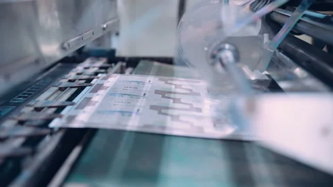 A cutting machine in a printing shop cuts printed packaging. Stock Footage 197462996
