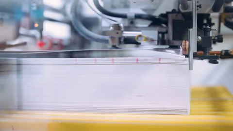 A cutting machine in a printing shop cuts a large pile of printed packaging. Stock Footage 197463007