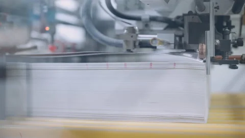 A cutting machine in a printing shop cuts a large pile of printed packaging. Stock Footage 197463486