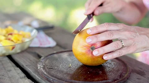 Cutting mango to add to fruit salad Stock Footage 63292543