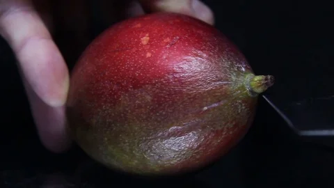 Cutting mango in a half. Stock Footage 98662306