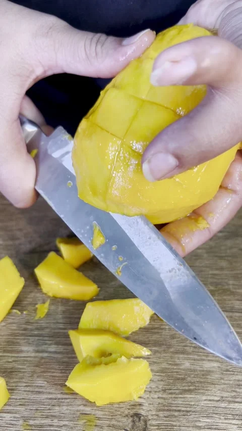 Cutting mango into slices with knife. isolated mango cubes. Stock Footage 287811289