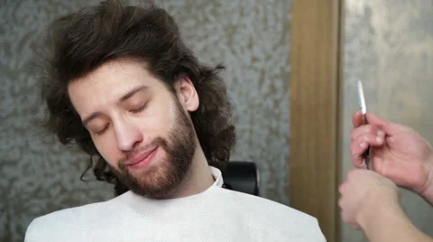 Cutting man's beard with the straight razor Stock Footage 62978654