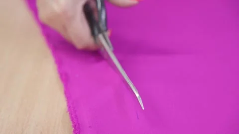 Cutting material for sewing clothes with scissors in sewing workshop. Stock Footage 250337913