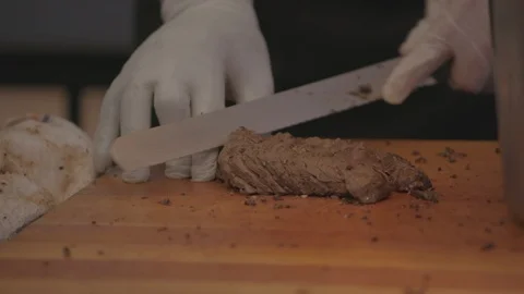 Cutting meat and putting it on a plate Stock Footage 103873757