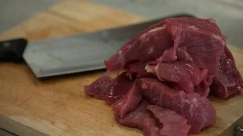Cutting meat on board Stock Photos