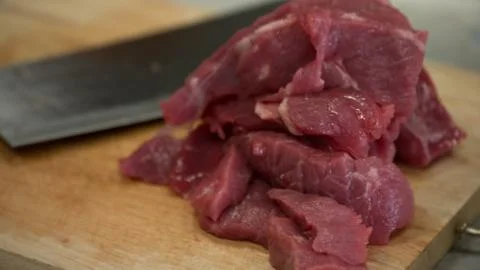 Cutting meat on board Stock Photos