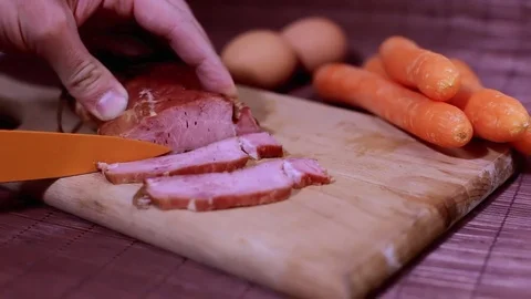 Cutting meat on the kitchen board Stock Footage 72164654