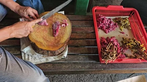 Cutting meat to make satay Stock Footage 251656055