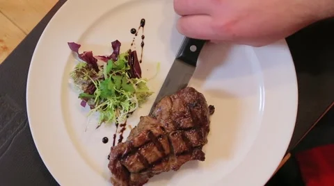 Cutting the meat on a plate close-up Stock Footage 61157775