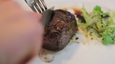 Cutting the meat on a plate close-up Stock Footage 61157863
