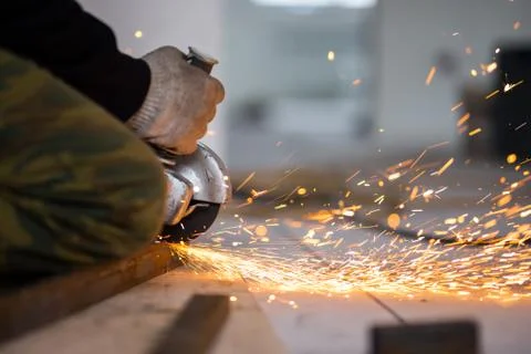 Cutting metal with angle grinder. Stock Photos