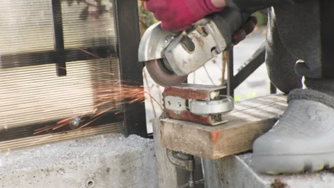 Cutting Metal with an Angle Grinder Sparks Fly as Precision Work Takes Center Stock-Footage 312437577