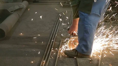 Cutting metal with angular grinding machine and a lot of sparks. Violation of Stock Footage 76392715