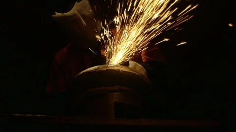 Cutting a metal disc in front. Human Stock Footage 95775644