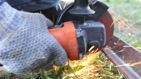 Cutting metal with a grinder in outdoor setting Stock Footage 344180515