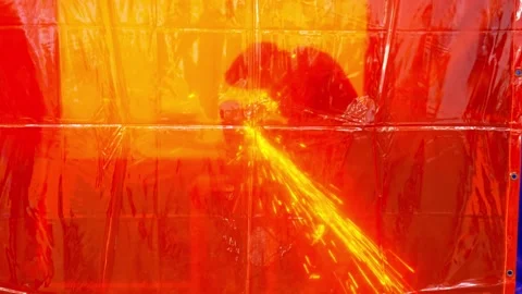 Cutting metal with a grinder under a protective film in slow motion Stock Footage 246437932