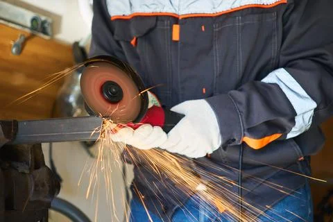 Cutting a metal part with an angle grinder 스톡 사진