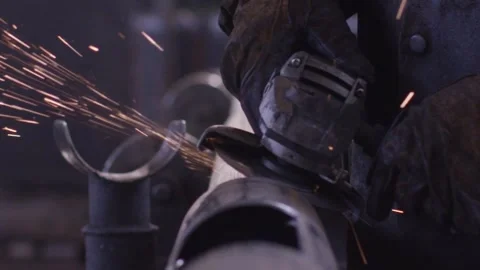 Cutting Metal Pipe With Angle Grinder, Sparks Flying, Dark Workshop Stock Footage 341303979