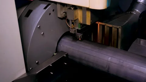 Cutting metal pipe with laser machine tool in workshop Stock Footage 258153276