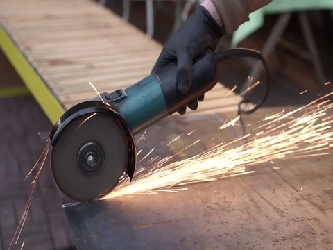 Cutting a metal sheet with angle grinder with much sparks Stock Footage 112656591