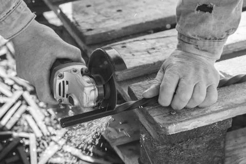 Cutting metal using the angle grinder, workflow is closeup, colorless effect Fotos Stock