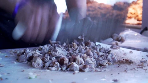 Cutting up Mexican carnitas  Stock Footage 121728323