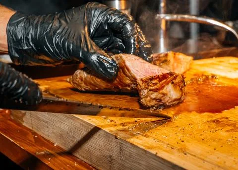 Cutting Midium Steak into Pieces with a Sharp Knife 写真素材