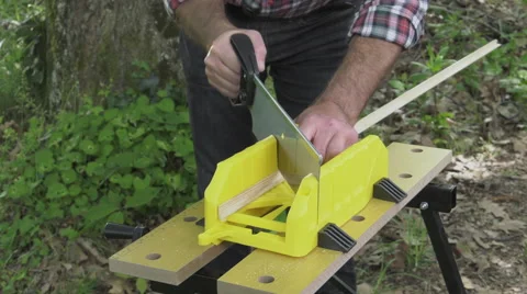 Cutting mitered cuts using saw and mitre box Video stock 63505519