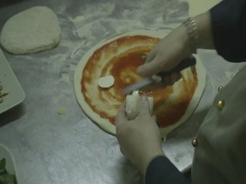 Cutting mozzarella cheese on a pizza dough 10 Stock Footage 80674331