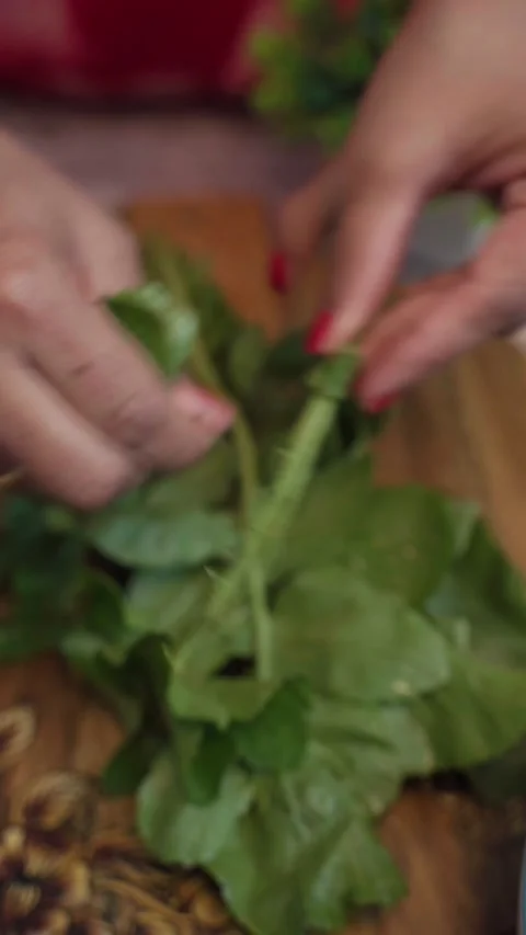 Cutting of muli leaf or radish vegetable by hand on a chopping board. Stock Footage 283364488