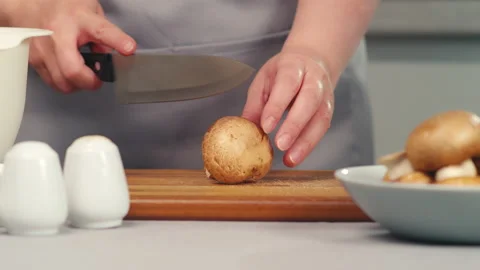 Cutting mushrooms in half on board Video stock 165596740
