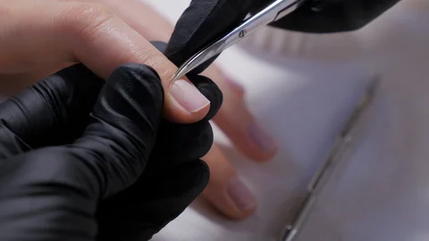 Cutting off the nails cuticle by nail scissors in professional nail salon. Stock Footage 119635895