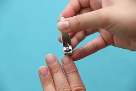 Cutting the nails with nail clipper Stock Photos