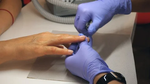 Cutting off the nails By nail scissors in professional nail salon. Beautiful fem Stock Footage 96328708