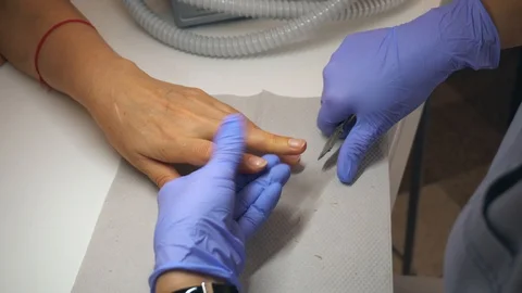 Cutting off the nails By nail scissors in professional nail salon. Beautiful fem Stock Footage 96329163