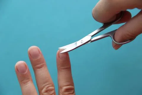 Cutting the nails with scissors 스톡 사진