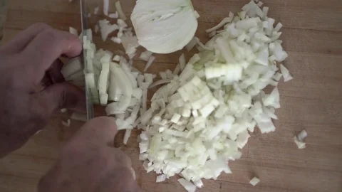 Cutting oinon into small cubes, pov Stock Footage 83602628