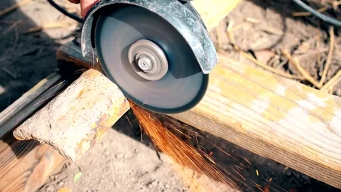 Cutting old rusted iron pipe with an angle grinder outdoors Video stock 71167631