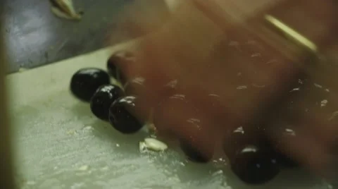 Cutting olives on a chopping board Video stock 44386856
