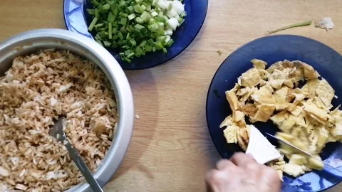 Cutting omelet on the table with onion and rice Stock Footage 119846438